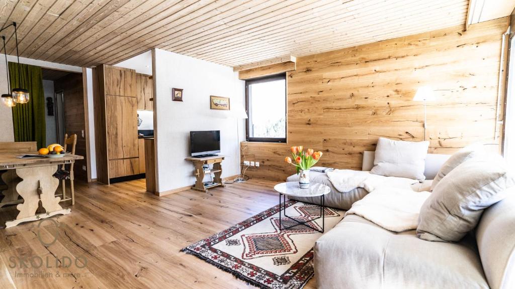 a living room with a couch and a table at Haus Camillo in Saas-Fee