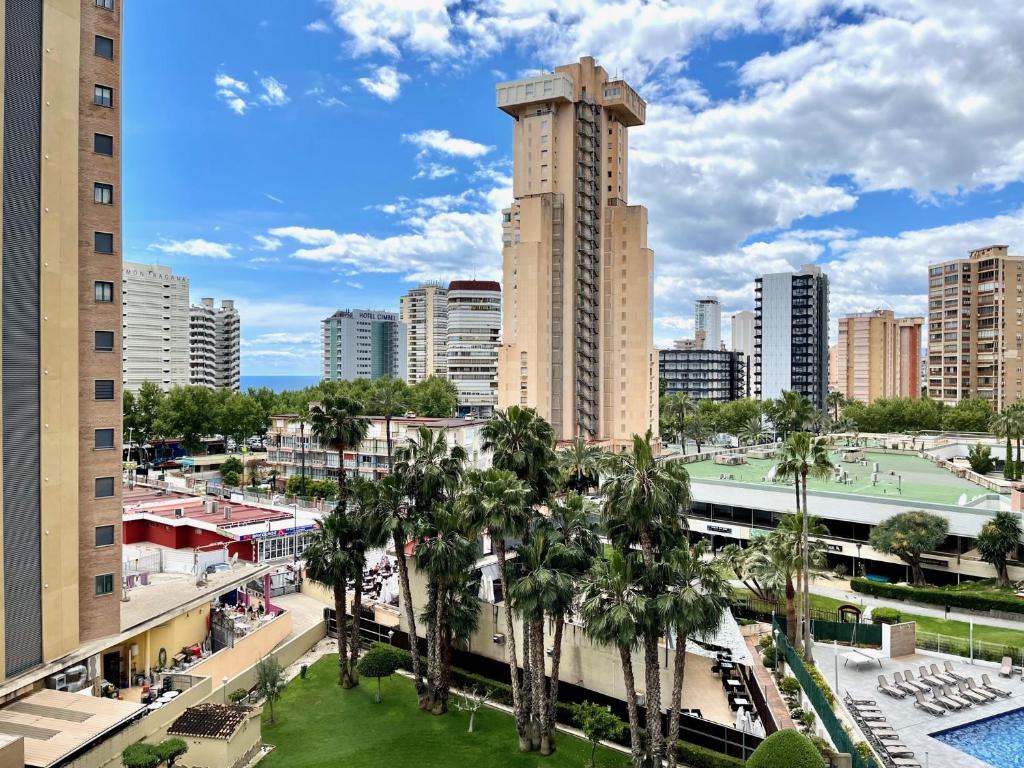 a view of a city with palm trees and buildings at Torpa - Aloturin Benidorm in Benidorm