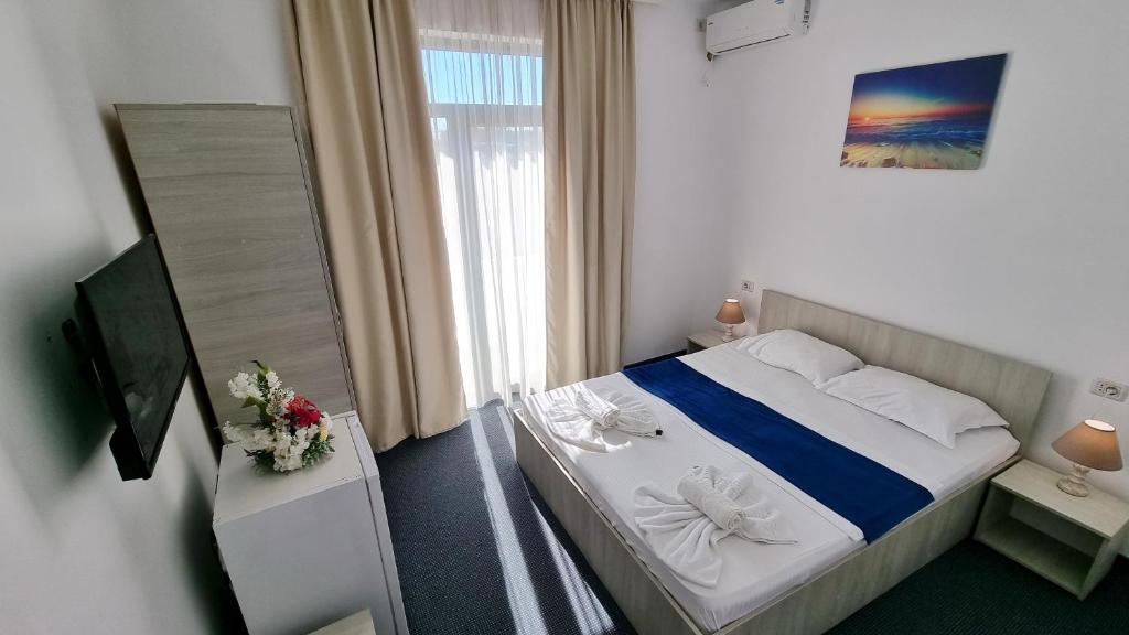 Postel nebo postele na pokoji v ubytování Neptun Resort