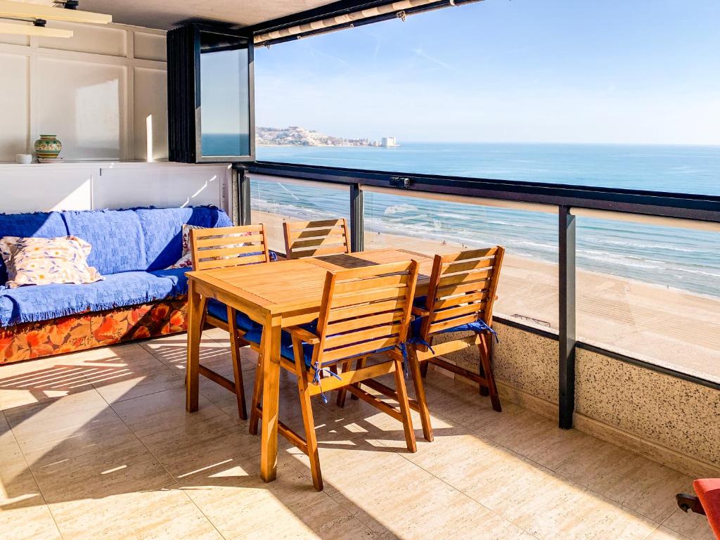 a table and chairs on a balcony with a view of the ocean at ESPACIO 15 - Primera Línea de Playa in Cullera