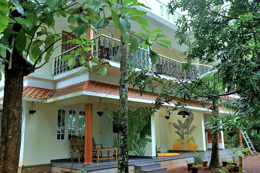 a house with a balcony on top of it at Aryavilla Heritage in Varkala