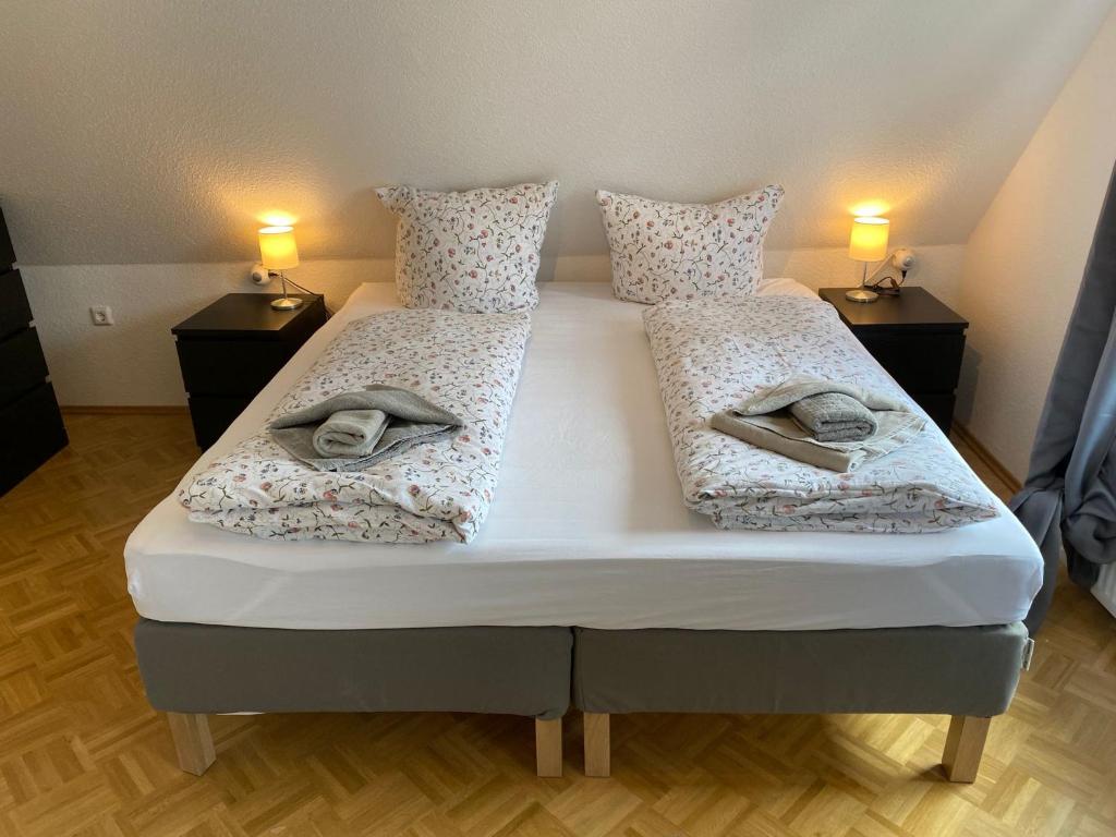 a bedroom with two beds with towels on them at Ferienhaus am Seedeich in Emden