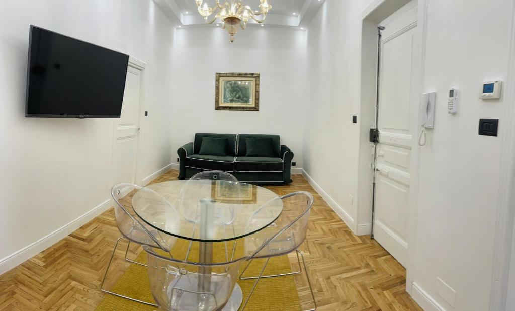 een woonkamer met een glazen tafel en een stoel bij Central Suite in Rome