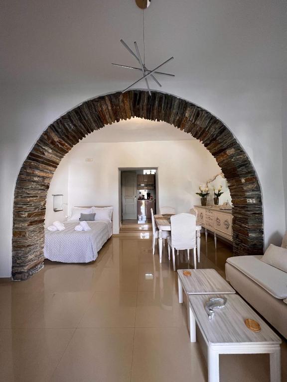 a living room with a bed and a table at Marianna's Studio in Tinos