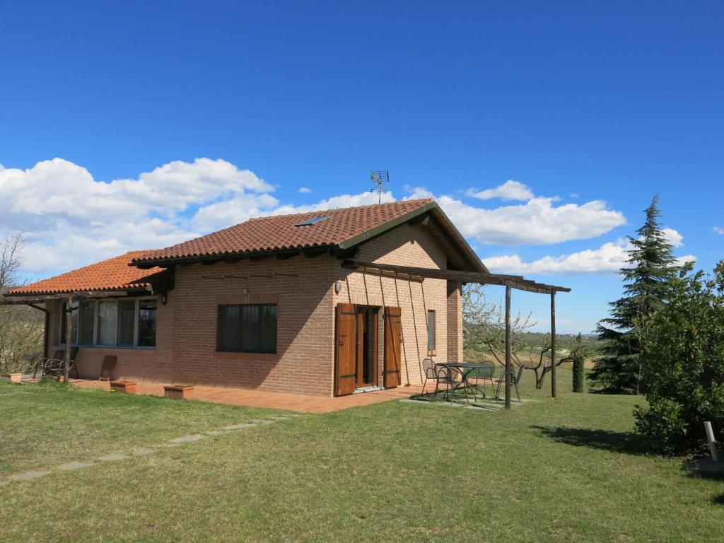 a small brick house in a field of grass at Holiday Home Le Rose Rosse by Interhome in Grazzano Badoglio