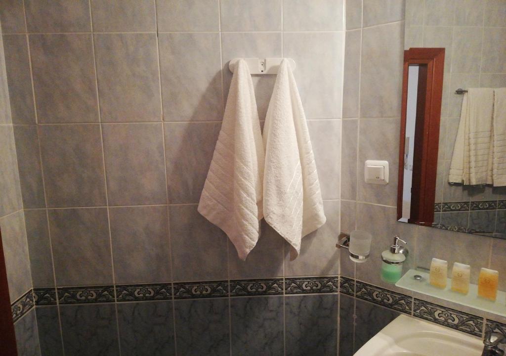 a bathroom with two towels hanging on a wall at Charis Cozy Family apart at Sun Village Complex close to the Beach in Sunny Beach