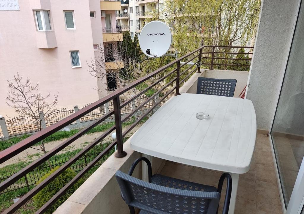 a white table and chairs on a balcony at Charis Cozy Family apart at Sun Village Complex close to the Beach in Sunny Beach