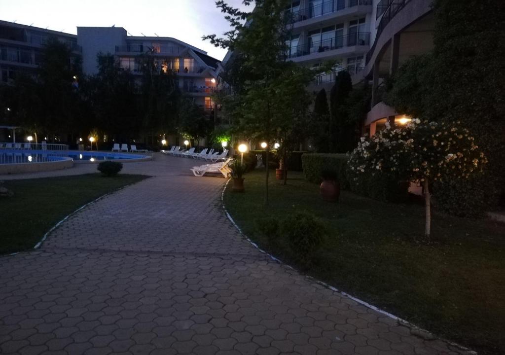 a cobblestone walkway in a city at night at Charis Cozy Family apart at Sun Village Complex close to the Beach in Sunny Beach