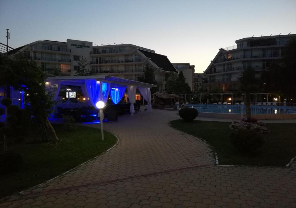 a blue tent in the middle of a city at night at Charis Cozy Family apart at Sun Village Complex close to the Beach in Sunny Beach