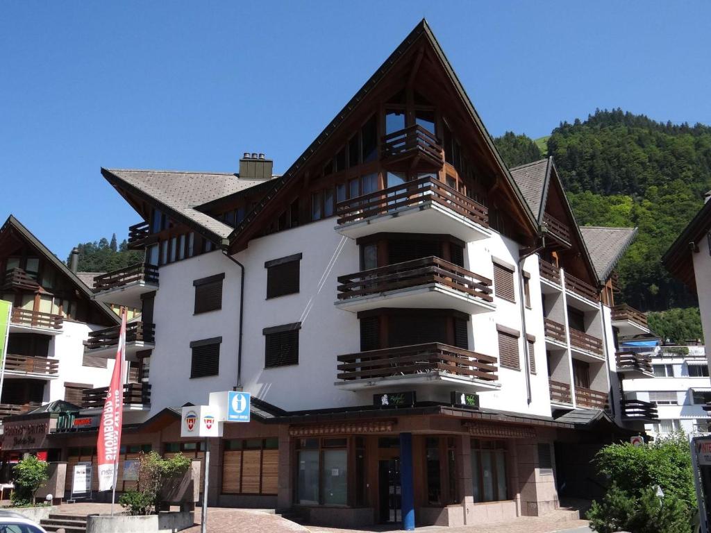 a large white building with a wooden roof at Apartment Bierlialp-Park A35 by Interhome in Engelberg