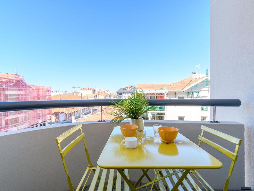een tafel met twee kopjes en een plant op een balkon bij Studio Feodorowka-1 by Interhome in Arcachon