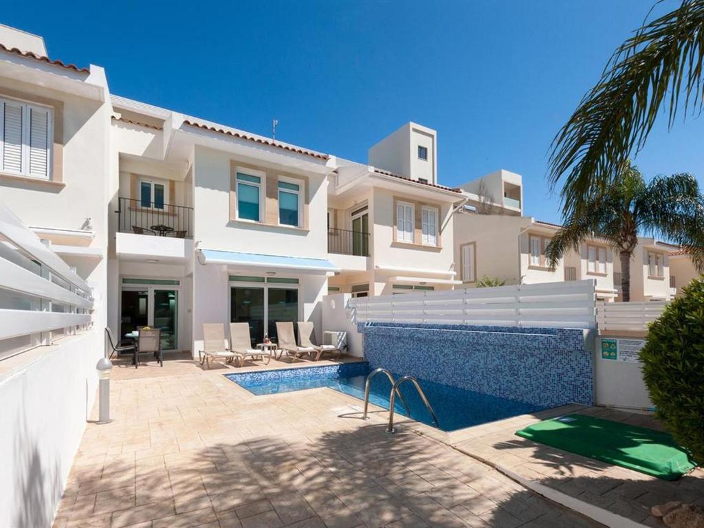 a villa with a swimming pool in front of a house at Villa elsa by Interhome in Protaras