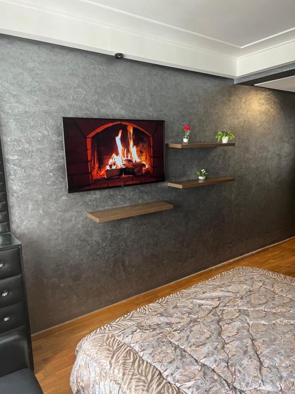 a living room with a fireplace on the wall at Deluxe apartments in Casablanca