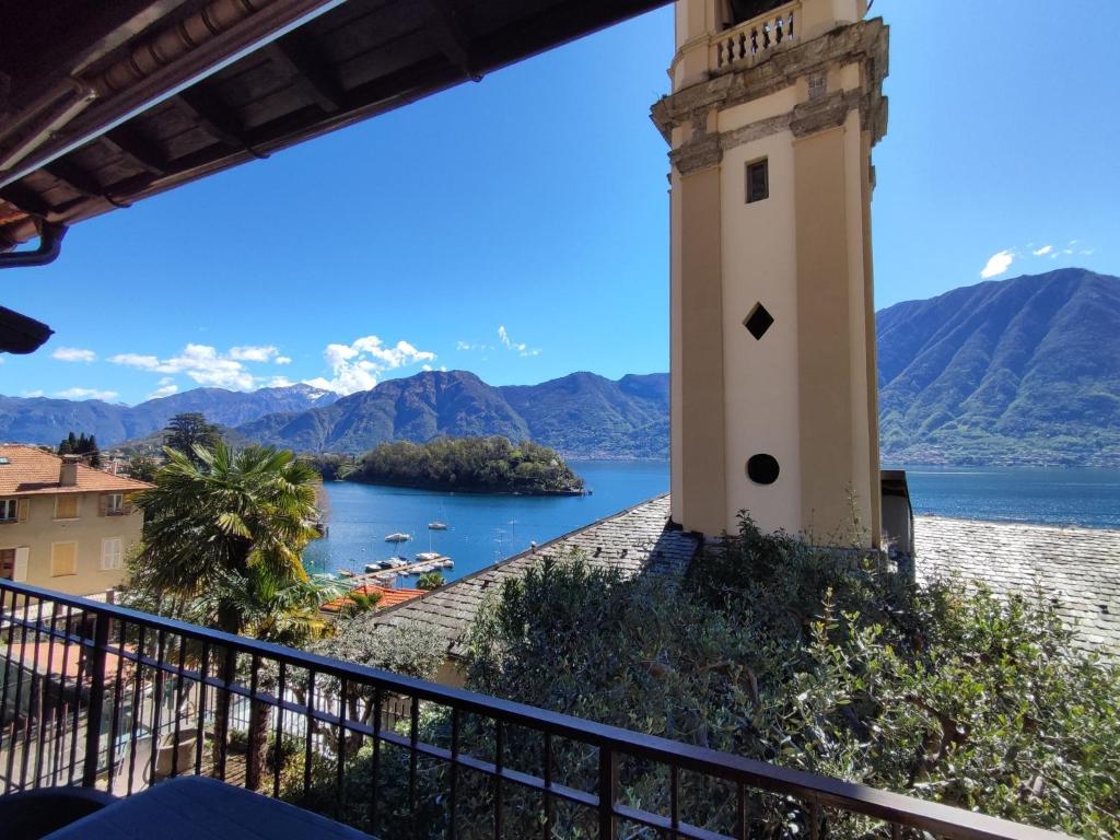 a lighthouse on a hill overlooking a body of water at Holiday Home Tower Bell House by Interhome in Isola Comacina