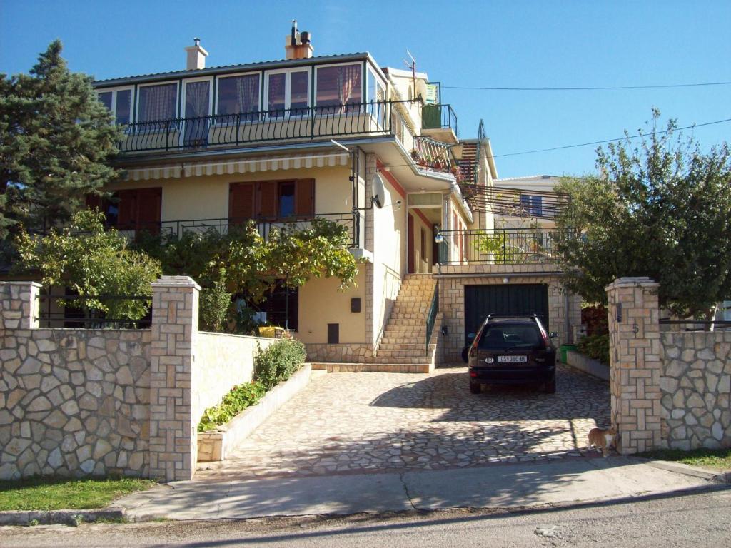 a car parked in front of a large house at Guest House Julia in Senj