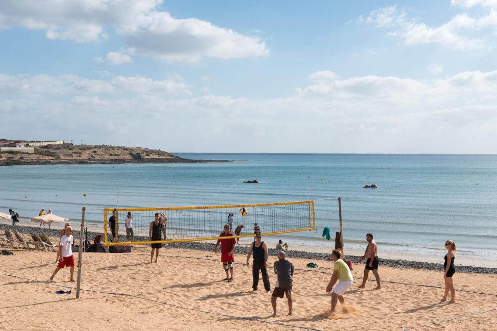 a group of people playing soccer on the beach at Sotavento Beach Club in Costa Calma