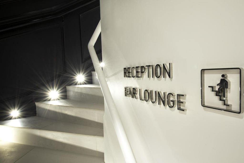 a white staircase with a sign that reads insertion exchange at Vertigo Hotel, By Marriott, a Member of Design Hotels in Dijon