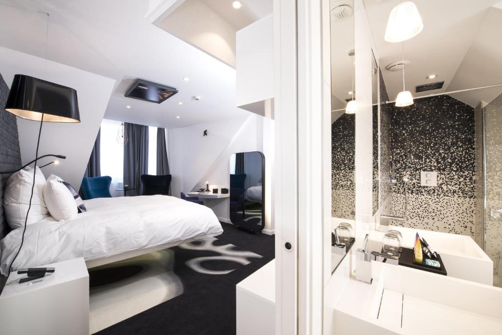 a hotel room with a bed and a shower at Vertigo Hotel, By Marriott, a Member of Design Hotels in Dijon