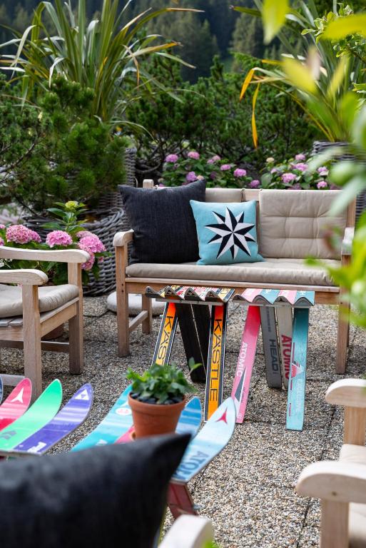 a patio with a couch and surfboards on the ground at Kristiania Lech in Lech am Arlberg