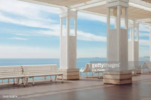 a row of benches on a building overlooking the ocean at Little Studio in Rue Biscarra in Nice
