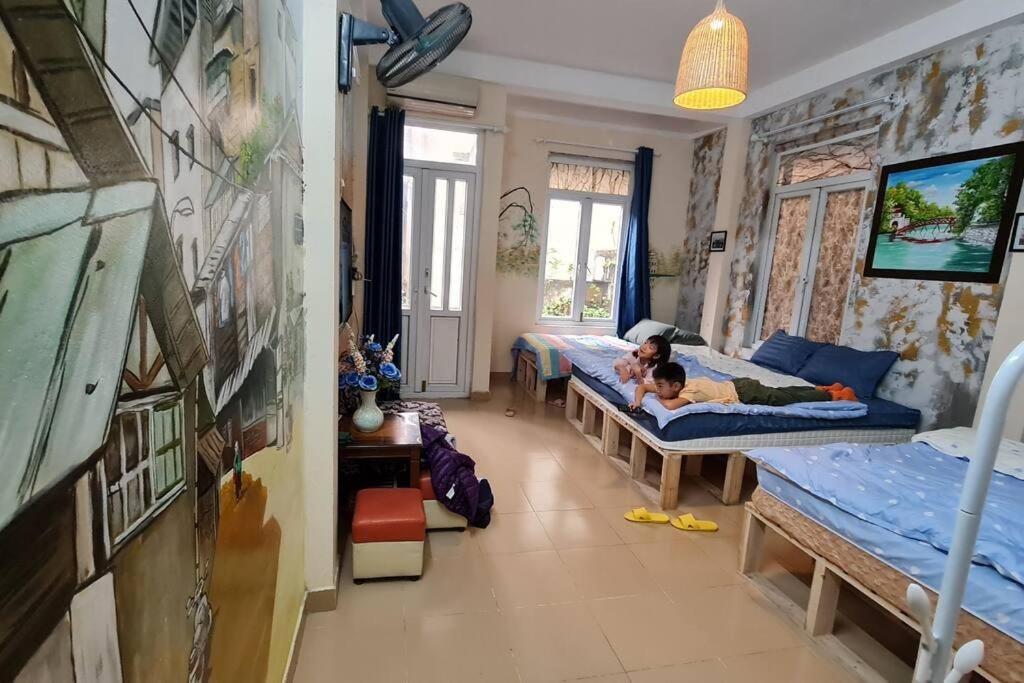 a child laying on a bed in a room with two beds at H2 homestay phố cổ check in tự động in Hanoi