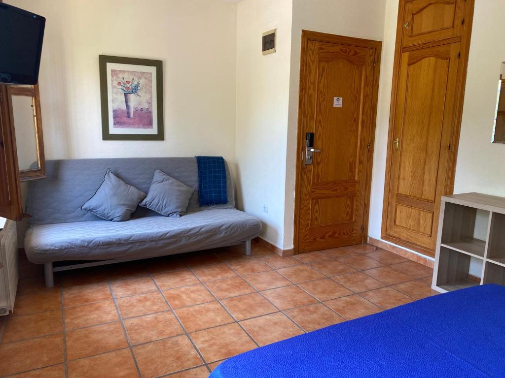 A bed or beds in a room at Hostal Moscatel