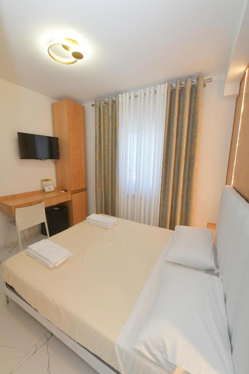 Łóżko lub łóżka w pokoju w obiekcie Noemi B&B