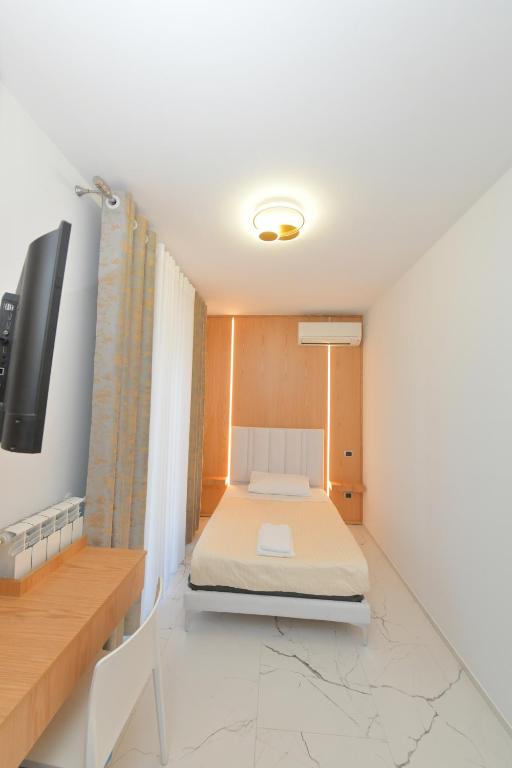 Łóżko lub łóżka w pokoju w obiekcie Noemi B&B