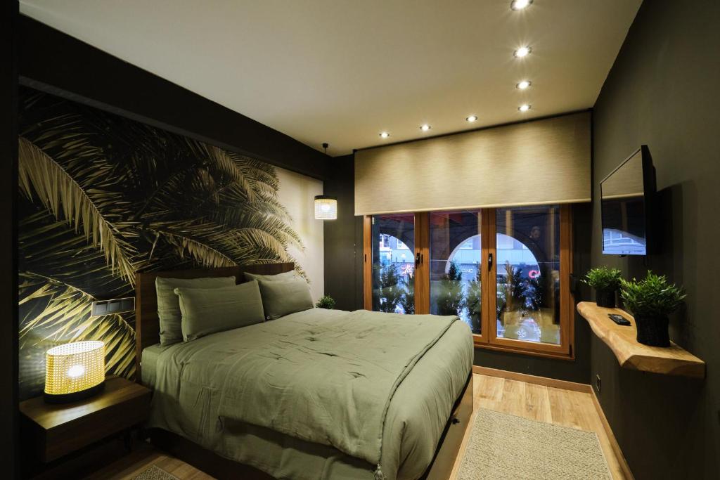 a bedroom with a large bed and a window at El Harapan - Sumérgete en una selva a pie de playa - Grupo Querbes in Gijón