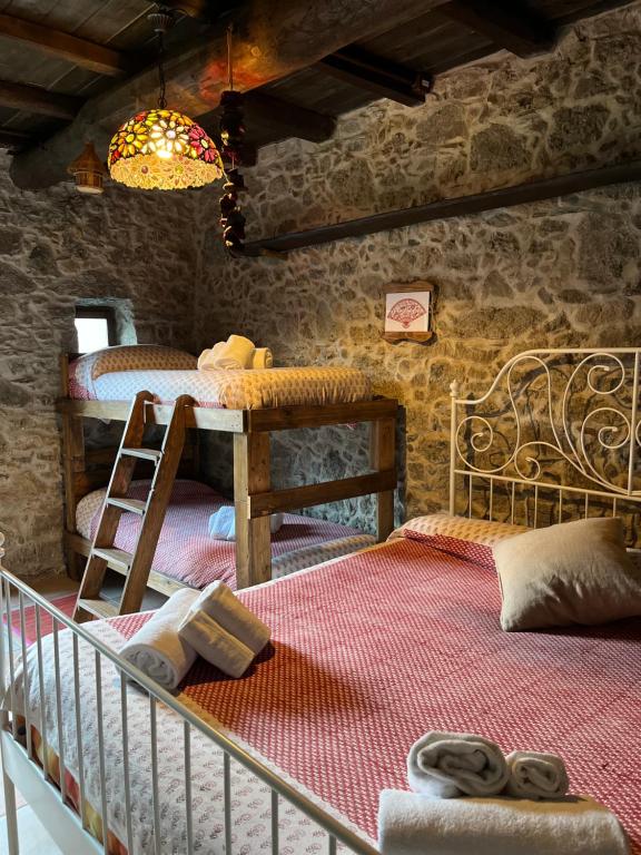 a bedroom with a bed and a table with a ladder at Casa Balsamo in Borzonasca