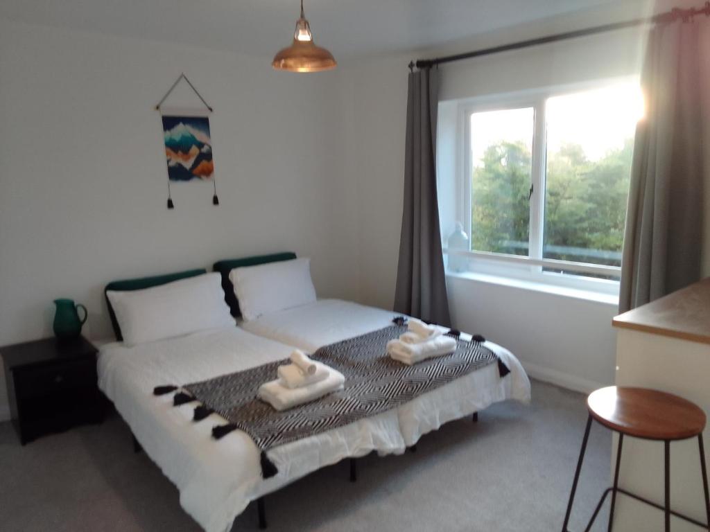 a bedroom with a bed with two towels on it at Beech House 20 minute walk to Airport in Bristol