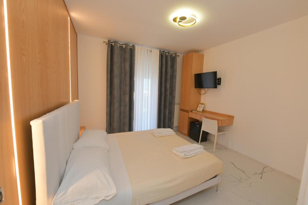 Łóżko lub łóżka w pokoju w obiekcie Noemi B&B