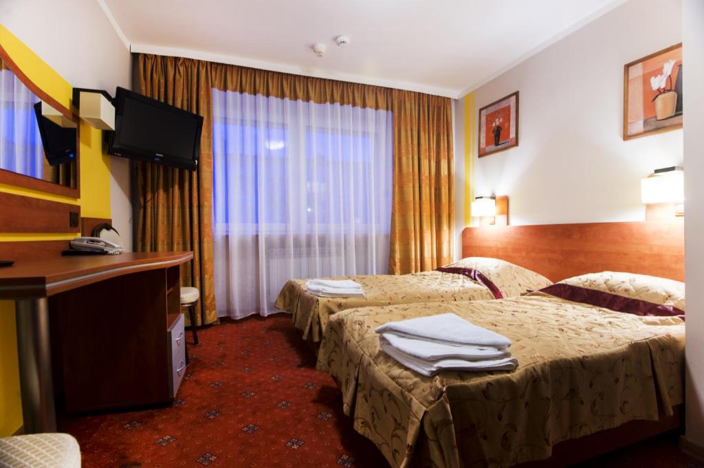 Postel nebo postele na pokoji v ubytování Hotel Orion