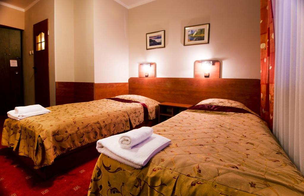 Postel nebo postele na pokoji v ubytování Hotel Orion