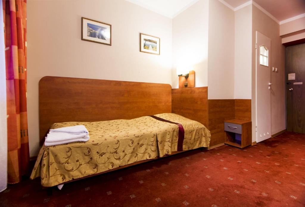 Postel nebo postele na pokoji v ubytování Hotel Orion