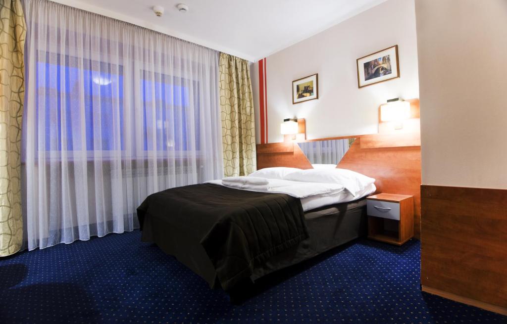 Postel nebo postele na pokoji v ubytování Hotel Orion