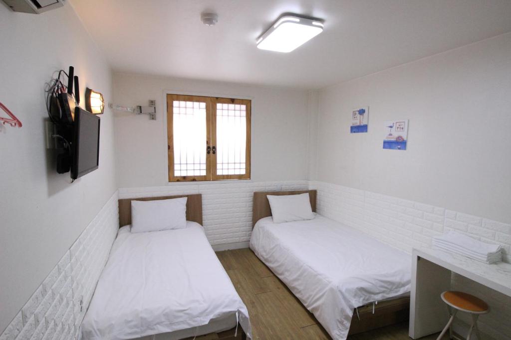 Cama ou camas em um quarto em Hotel Golden Park Myeongdong