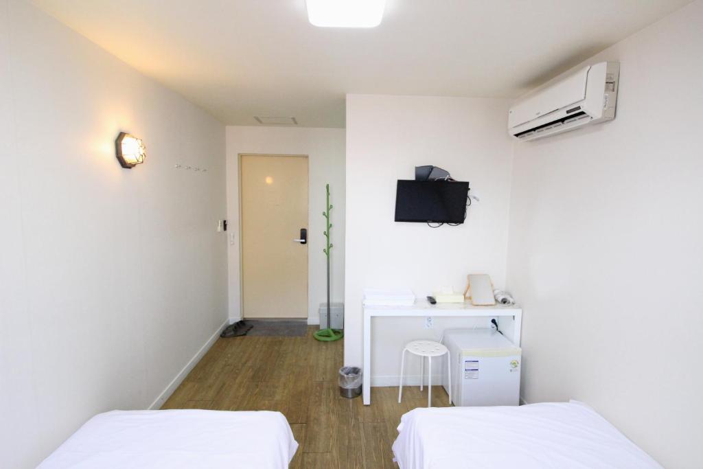 Cama ou camas em um quarto em Hotel Golden Park Myeongdong