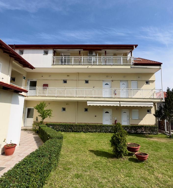 a large building with a large yard with plants at ANNA ROOMS (Villa Anna) in Nea Vrasna