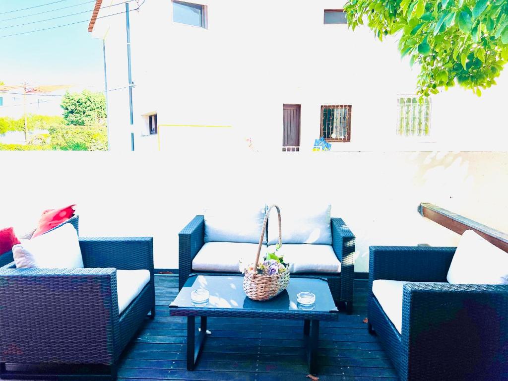 a patio with couches and a table on a patio at Estoril Seaside Guest House in Estoril