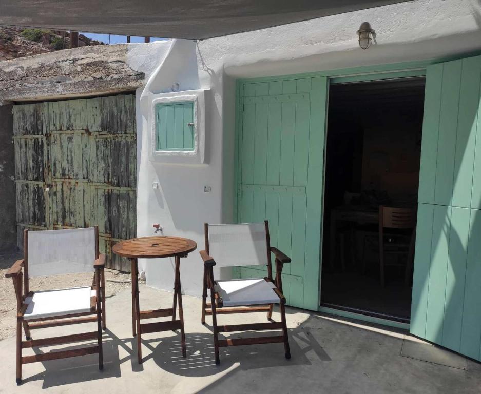 two chairs and a table on a patio at Apanemo Beach House Agios Nikolaos Kimolos in Kimolos