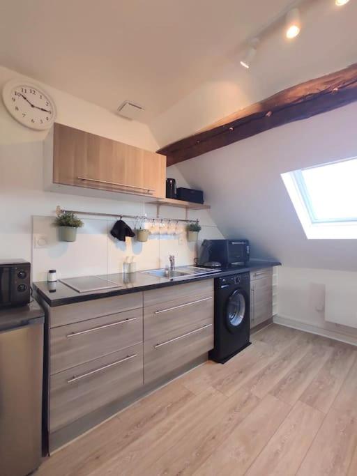 a kitchen with a sink and a dishwasher at Equidia Compiègne Free Parking Wifi Self Check-in in Venette