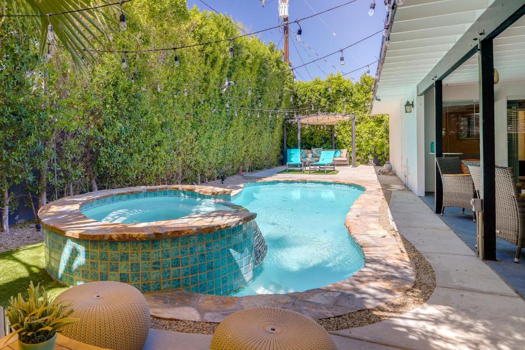 a swimming pool in the backyard of a house at Sunny Palm Springs Home with Private Pool and Patio! in Palm Springs