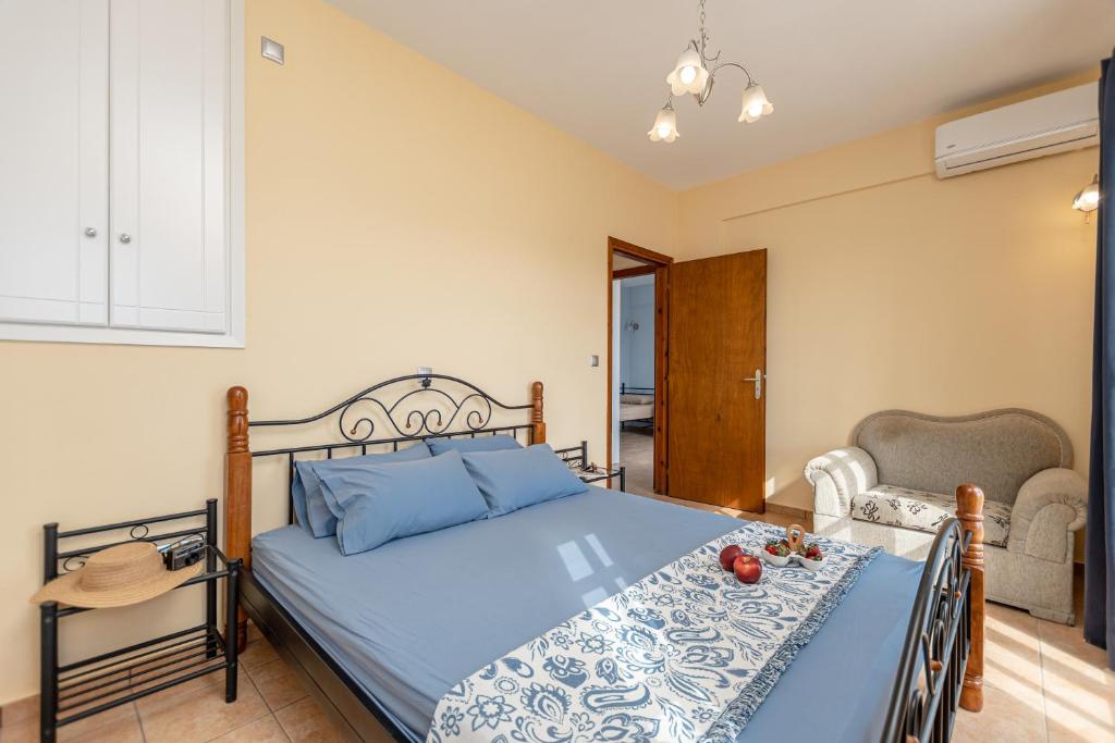 a bedroom with a blue bed and a chair at Nick & Debbie's two-storey apartment in Mélanes