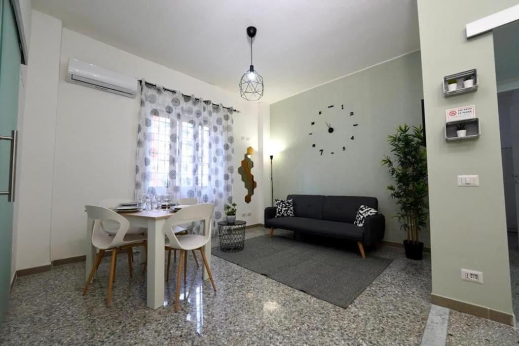 a living room with a table and a couch at Cinecittà Luxury Flat Metro A in Rome