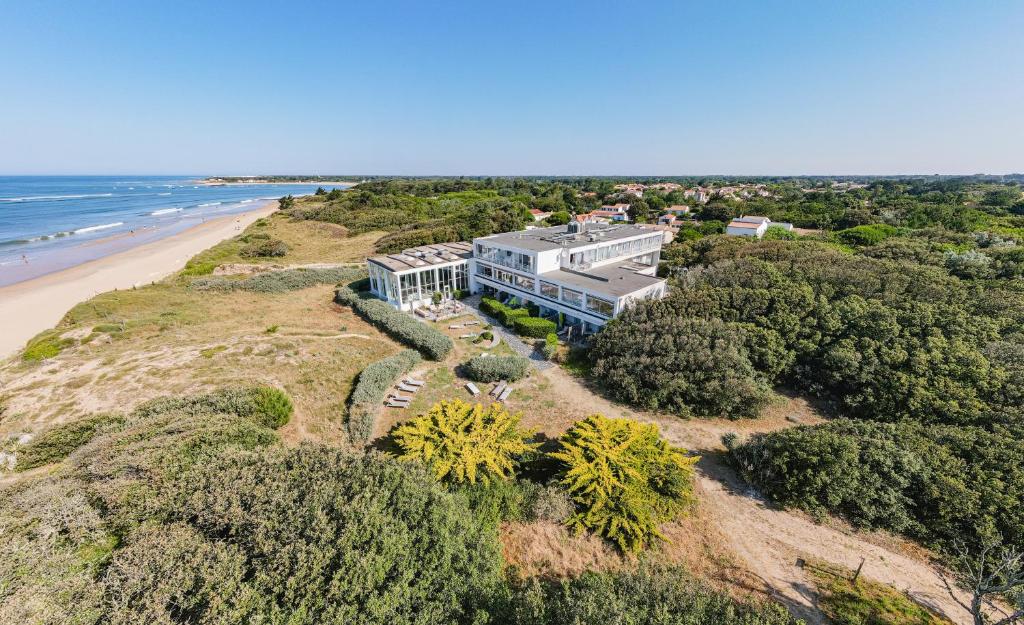 an aerial view of a house on a beach at Hôtel & Spa Le Grand Large in Dolus-d'Oléron