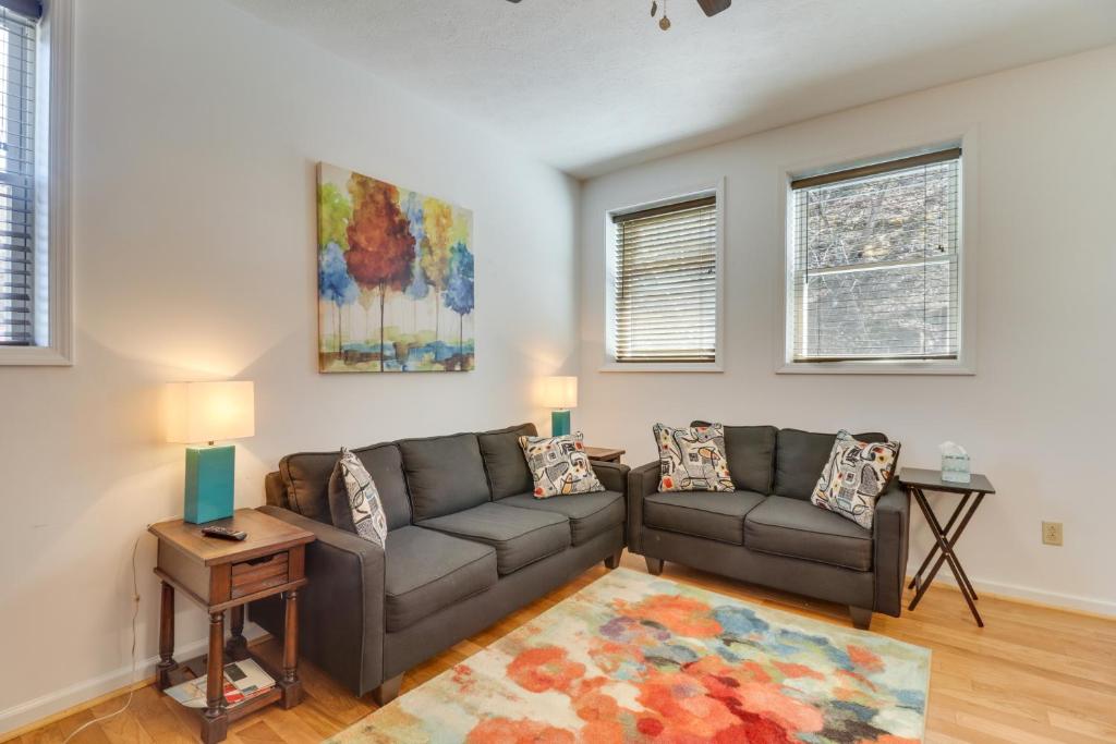 a living room with a couch and a table at Marlinton Vacation Rental on Riverfront Trail! in Marlinton