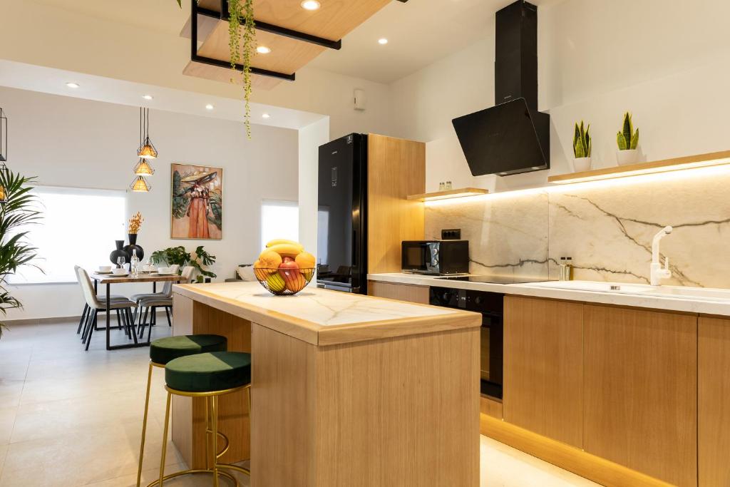 a kitchen with a island with a fruit bowl on it at Luxury New House near the Beach! - Casa Dionysia in Maleme