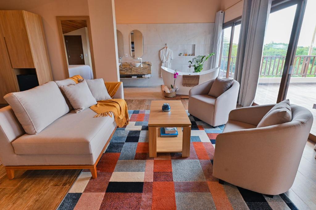 a living room with two couches and a coffee table at Oka Da Mata in Pipa