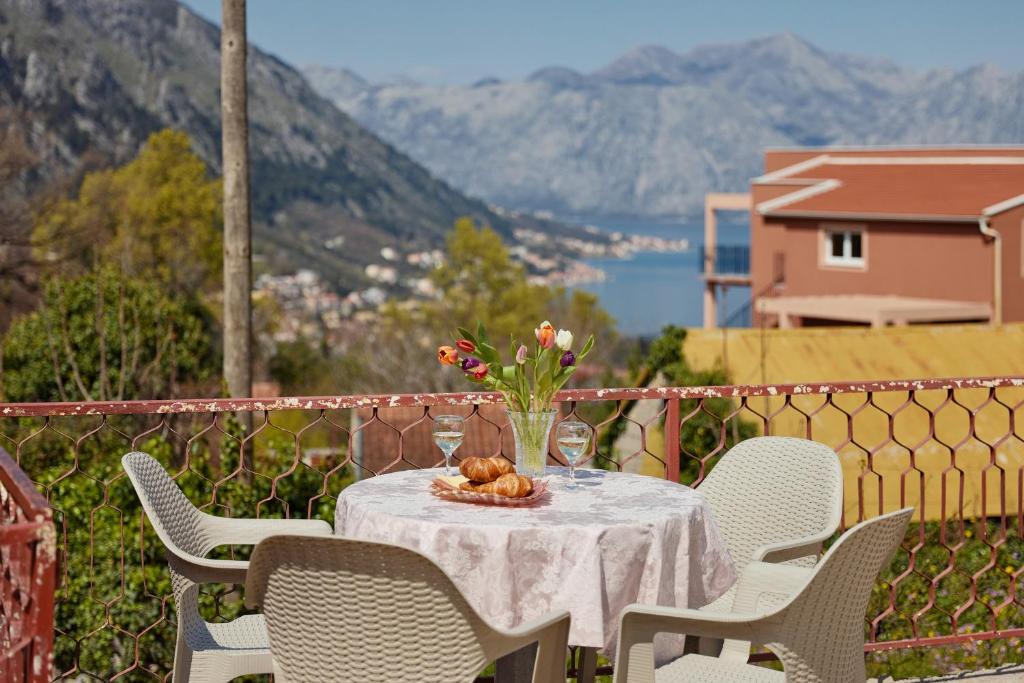 une table avec une assiette de nourriture et de fleurs dans l'établissement DREAM S&L, à Kotor